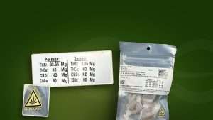 Montana cannabis product label on a sealed Salted Caramel edible pouch, with the THC potency panel and the state marijuana warning symbol shown enlarged